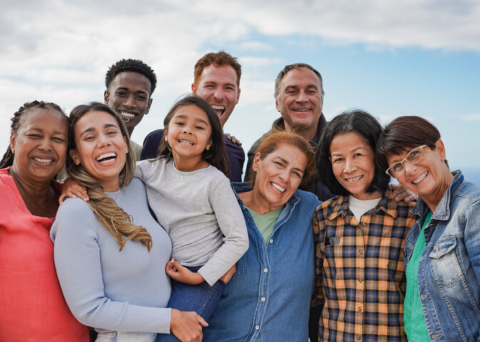 Group of multiracial people with different ages having fun together outdoor